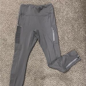 Fabletics Leggings size 10. Gray with side pockets and zippers at the ankles.